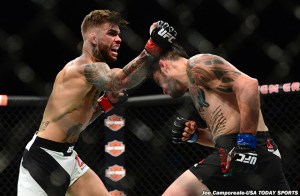 Jul 11, 2015; Las Vegas, NV, USA; Cody Garbrandt (red gloves) and Henry Briones (blue gloves) fight during UFC 189 at MGM Grand Garden Arena. Garbrandt won via unanimous decision. Mandatory Credit: Joe Camporeale-USA TODAY Sports