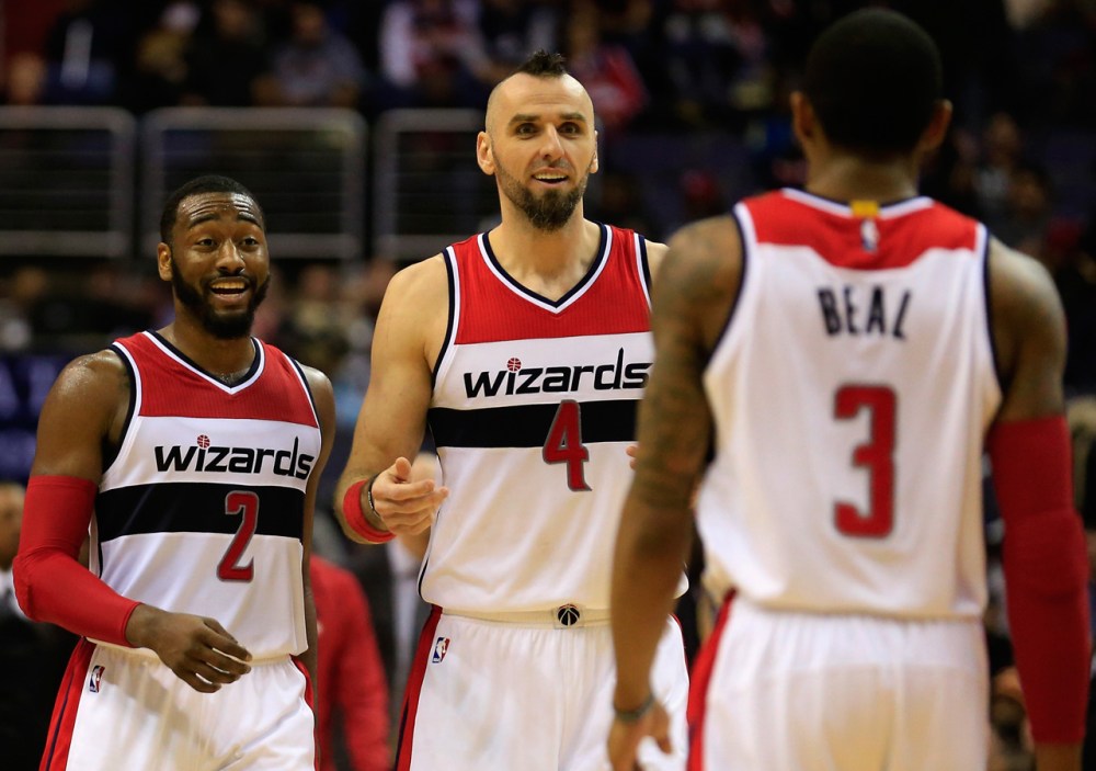WASHINGTON, DC - DECEMBER 16: John Wall #2, Marcin Gortat #4, and Bradley Beal #3 of the Washington Wizards celebrate during the closing mintues of the Wizards 109-95 win over the Minnesota Timberwolves at Verizon Center on December 16, 2014 in Washington, DC. NOTE TO USER: User expressly acknowledges and agrees that, by downloading and or using this photograph, User is consenting to the terms and conditions of the Getty Images License Agreement (Photo by Rob Carr/Getty Images)
