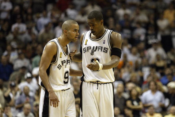 SAN ANTONIO - JUNE 6: Tony Parker #9 and Stephen Jackson #3 of the San Antonio Spurs go over strategy in Game two of the 2003 NBA Finals against the New Jersey Nets at SBC Center on June 6, 2003 in San Antonio, Texas. The Nets won 87-85. NOTE TO USER: User expressly acknowledges and agrees that, by downloading and/or using this Photograph, User is consenting to the terms and conditions of the Getty Images License Agreement. (Photo by Jed Jacobsohn/Getty Images)