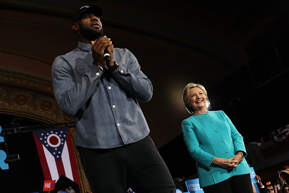 CLEVELAND, OH - NOVEMBER 06: LeBron James (R) speaks as Democratic presidential nominee former Secretary of State Hillary Clinton looks on during a campaign rally at the Cleveland Public Auditorium on November 6, 2016 in Cleveland, Ohio. With two days to go until election day, Hillary Clinton is campaigning in Florida and Pennsylvania. (Photo by Justin Sullivan/Getty Images)