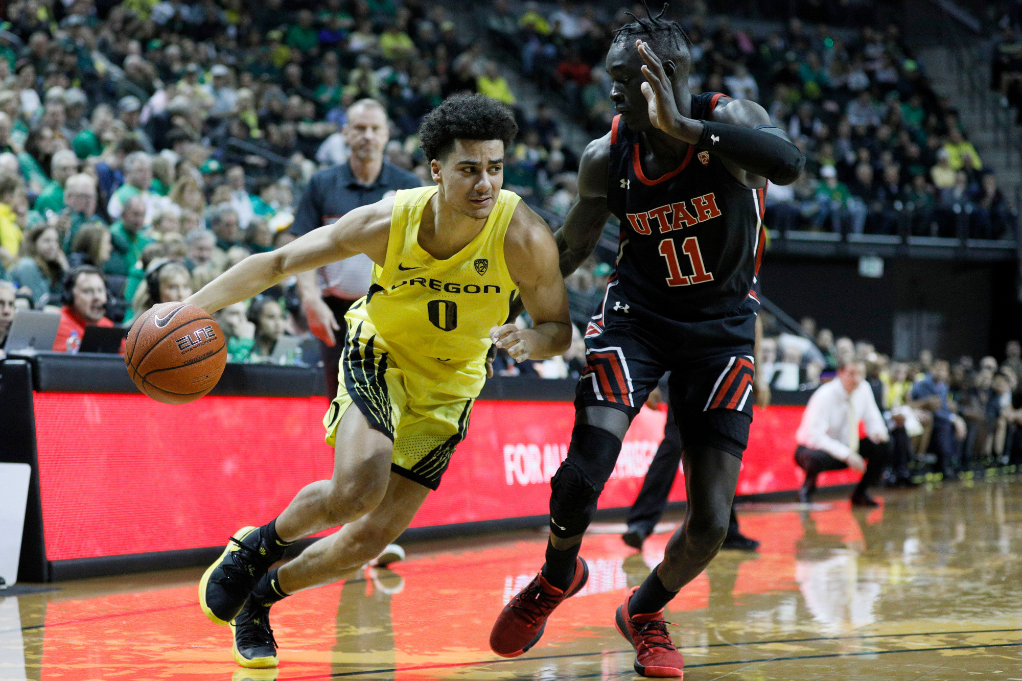 Feb 16, 2020; Eugene, Oregon, USA; Oregon Ducks guard Will Richardson (0) dribbles the ball as Utah Utes guard Both Gach (11) defends during the first half at Matthew Knight Arena.