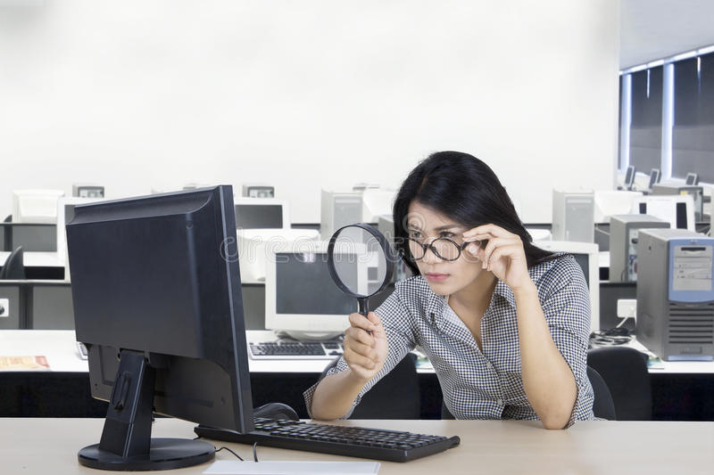 woman-looking-computer-magnifying-glass-young-businesswoman-office-86583069.jpg