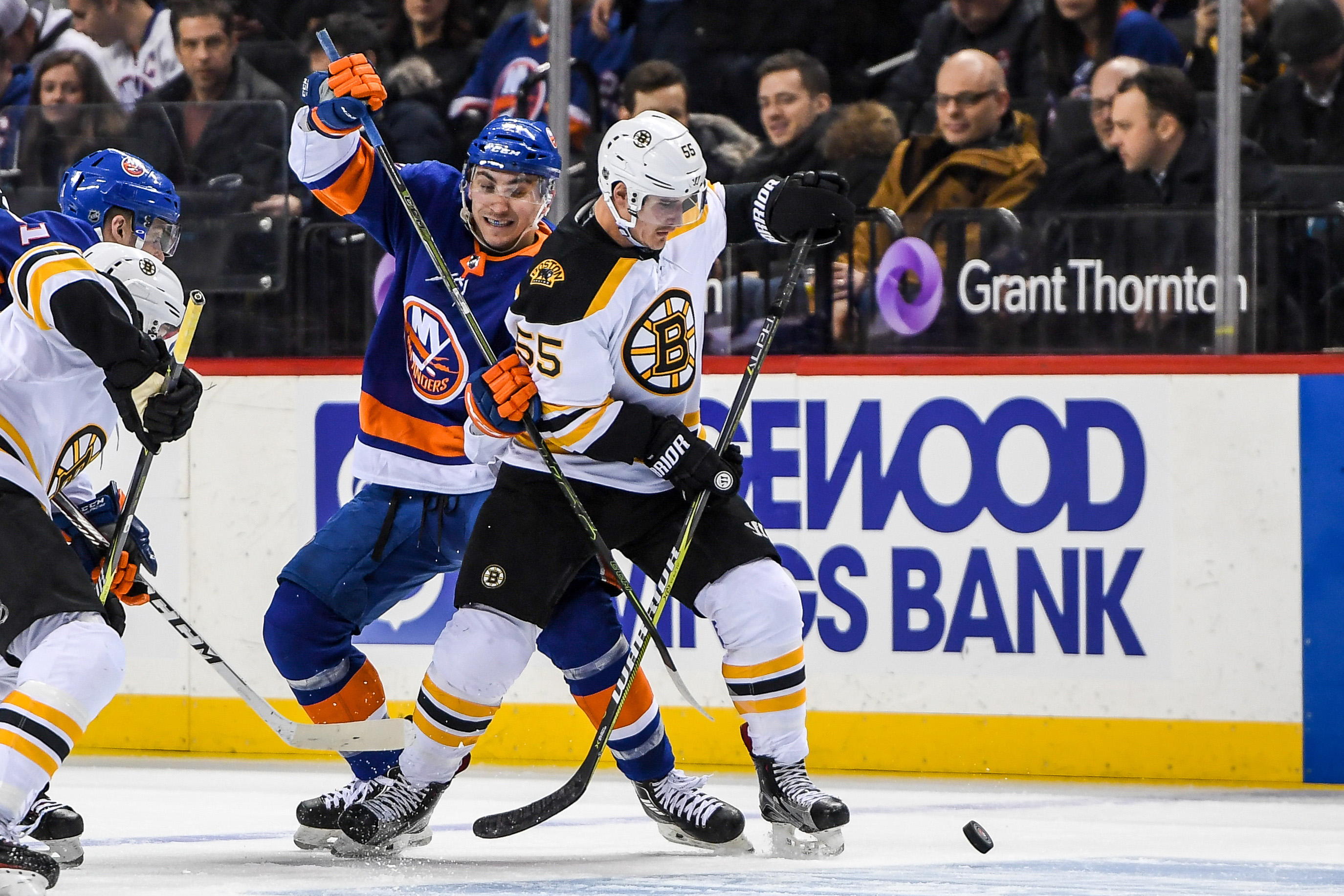Jan 18, 2018; Brooklyn, NY, USA; New York Islanders left wing Michael Dal Colle (71) and Boston Bruins center Noel Acciari (55) battle for the puck during the second period at Barclays Center. Mandatory Credit: Dennis Schneidler-USA TODAY Sports