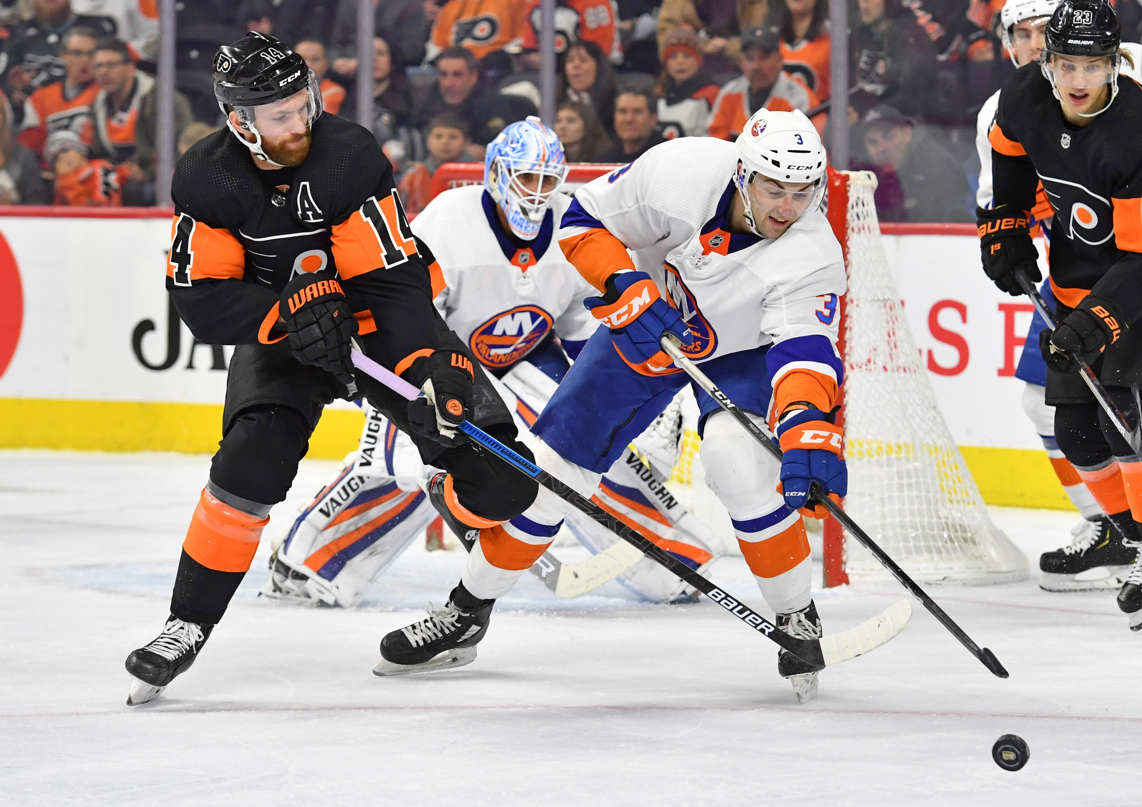 Nov 16, 2019; Philadelphia, PA, USA; New York Islanders defenseman Adam Pelech (3) clears the puck away from Philadelphia Flyers center Sean Couturier (14) during the second period at Wells Fargo Center. Mandatory Credit: Eric Hartline-USA TODAY Sports