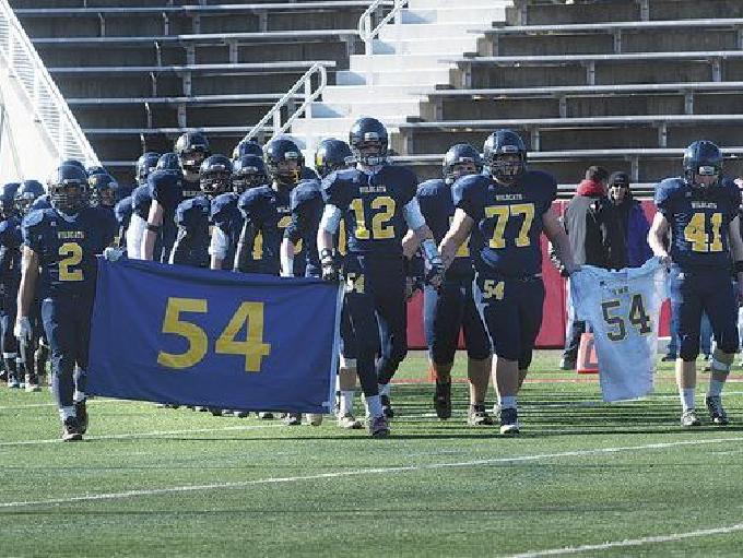 Members of the Shoreham-Wading River High School football team honor Tom Cutinella after his football-related death this season.
