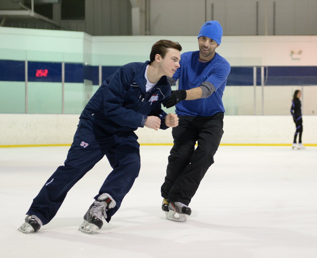 Two-time Olympic figure skater Michael Weiss tutors his son Chris, 15, who is a hockey player. (Photo by H. Darr Beiser)