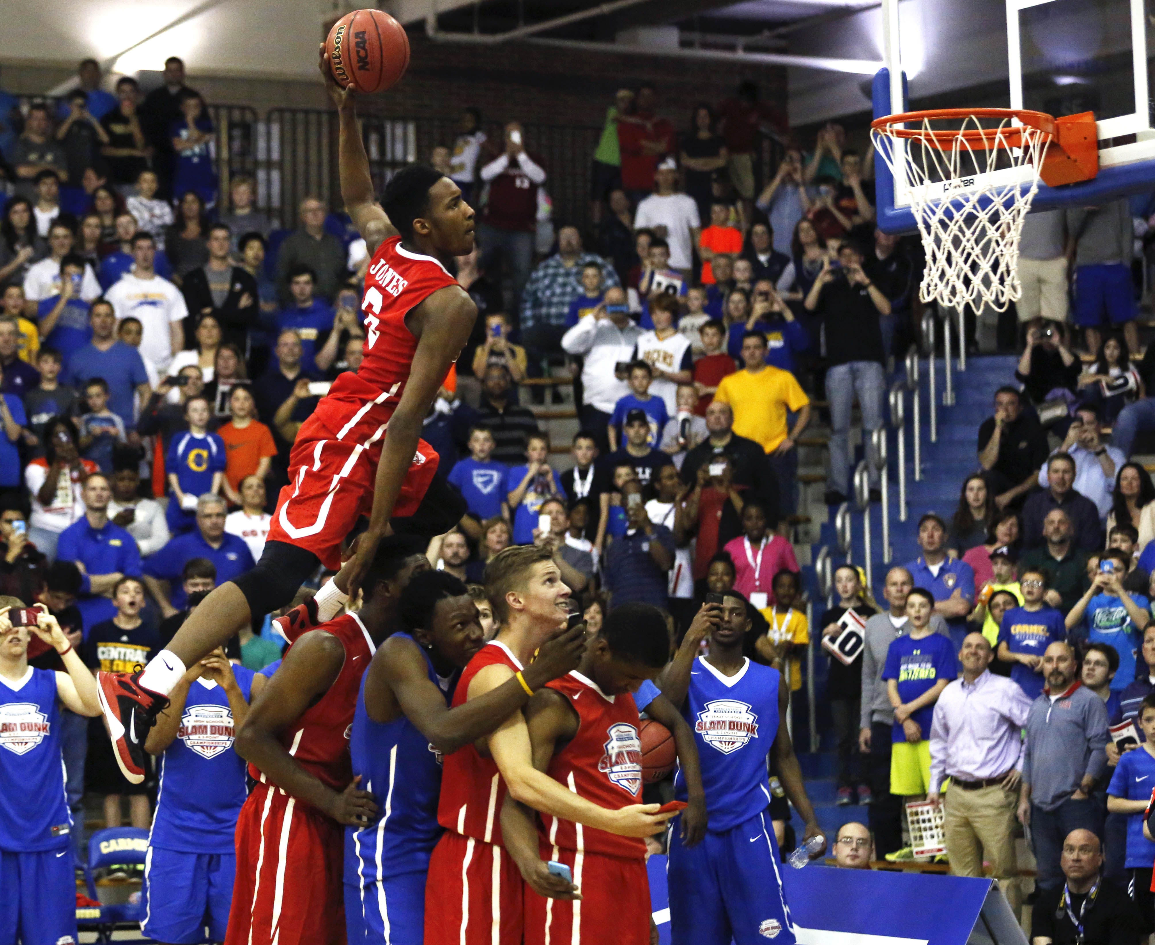 Derrick Jones leaps over teammates on his way to victory in the dunk contest at the American Family Insurance High School Slam Dunk and Three-Point Championship (Photo: Aaron Doster, USA TODAY  Sports)