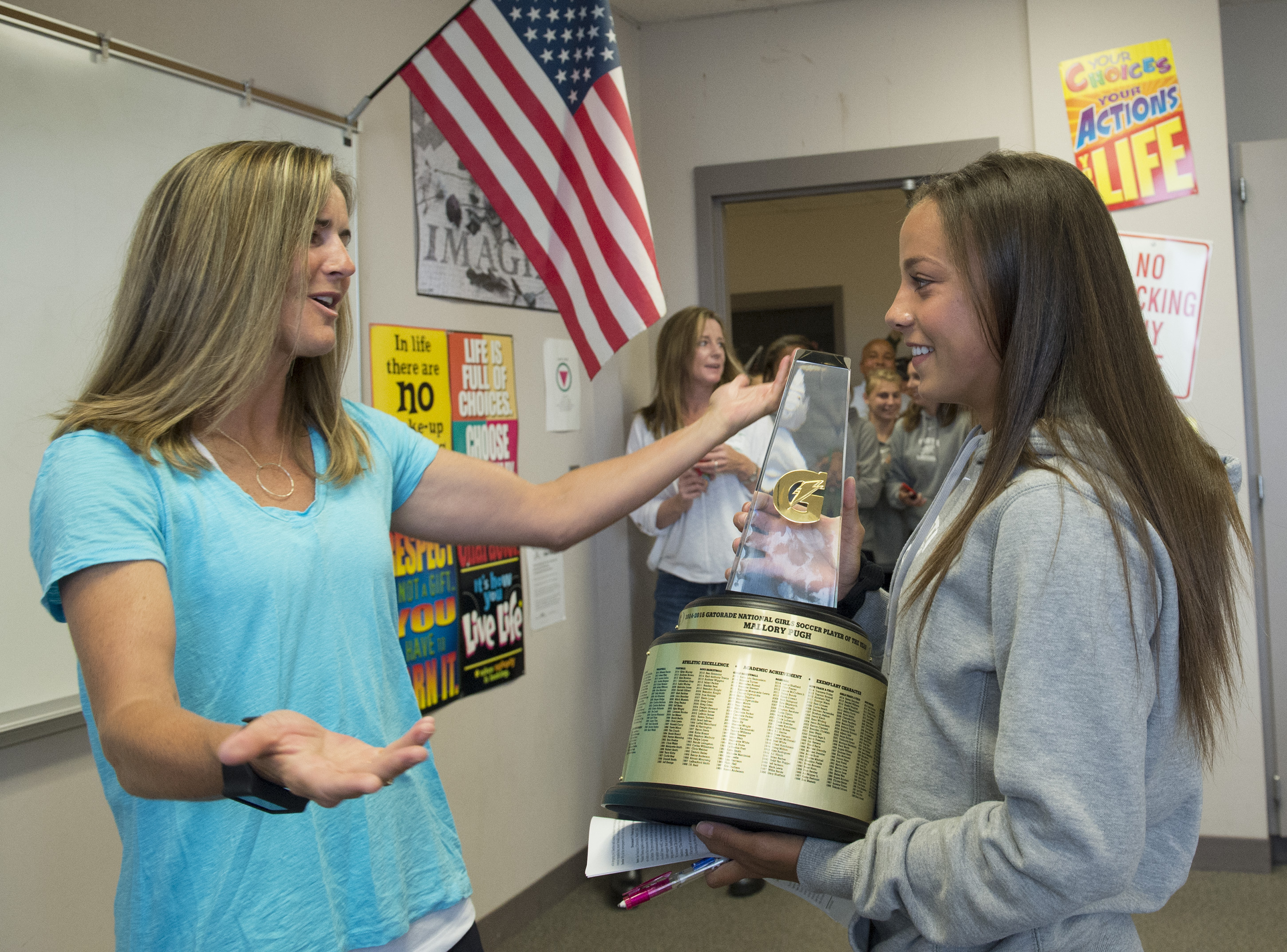 Mallory Pugh, right, of Mountain Vista High School, is surprised with the 2014-15 Gatorade National Girls Soccer Player of the Year trophy by Gold Medalist and World Cup Champion Brandi Chastain, Thursday, May 21, 2015 in Highlands Ranch, Colo. The award recognizes outstanding athletic excellence as well as high standards of academic achievement and exemplary character demonstrated on and off the field. Photo/Gatorade, Susan Goldman, handout.