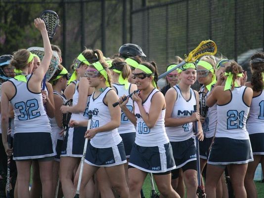 Mount Notre Dame breaks from its pre-game huddle and takes the field against McAuley on April 21. (Photo: Adam Baum/Community Press)