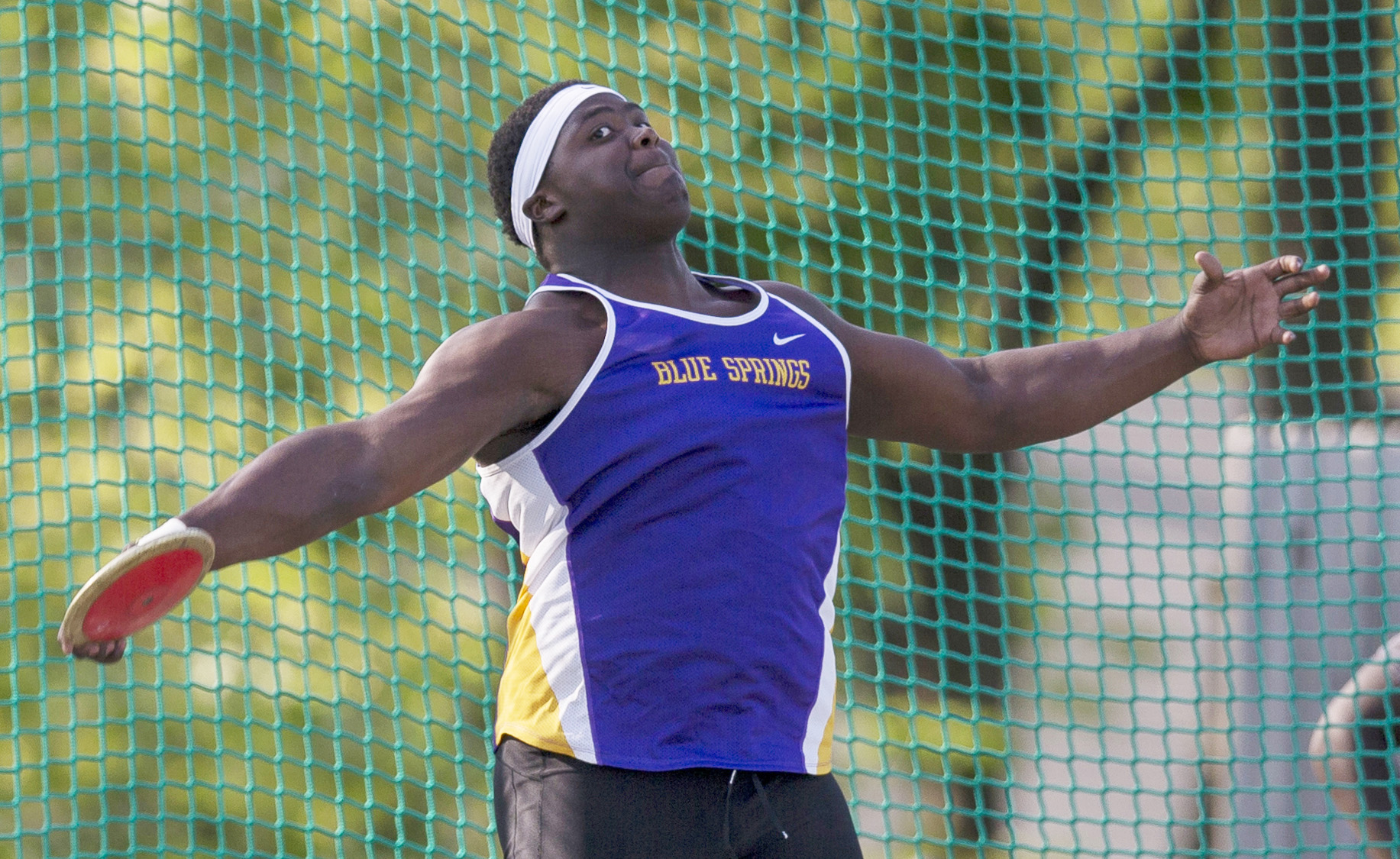 Blue Springs senior Carlos Davis unleashes a throw of 214 feet, 4 inches on his first attempt in the discus in the Gary Parker Invitational Thursday at Blue Springs High School. Davis' toss was the best high school throw in the nation this season as the Wildcats claimed the team title. Brian Davidson | Special to The Examiner