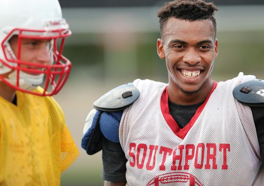 Southport's Paul Scruggs is all smiles while hanging with quarterback Luke Johnston between drills during practice, Aug. 12, 2015. (Photo: Matt Detrich, The Star)
