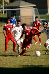 Butler High School's Igor Ibrahimkadic (17), center, battles for the ball against Fern Creek Kailash "KP" Pathak (8), right, at the Fern Creek v. Butler soccer game held at Fern Creek High School. Butler won 4-3, both teams were previously undefeated in their region. September 17, 2015