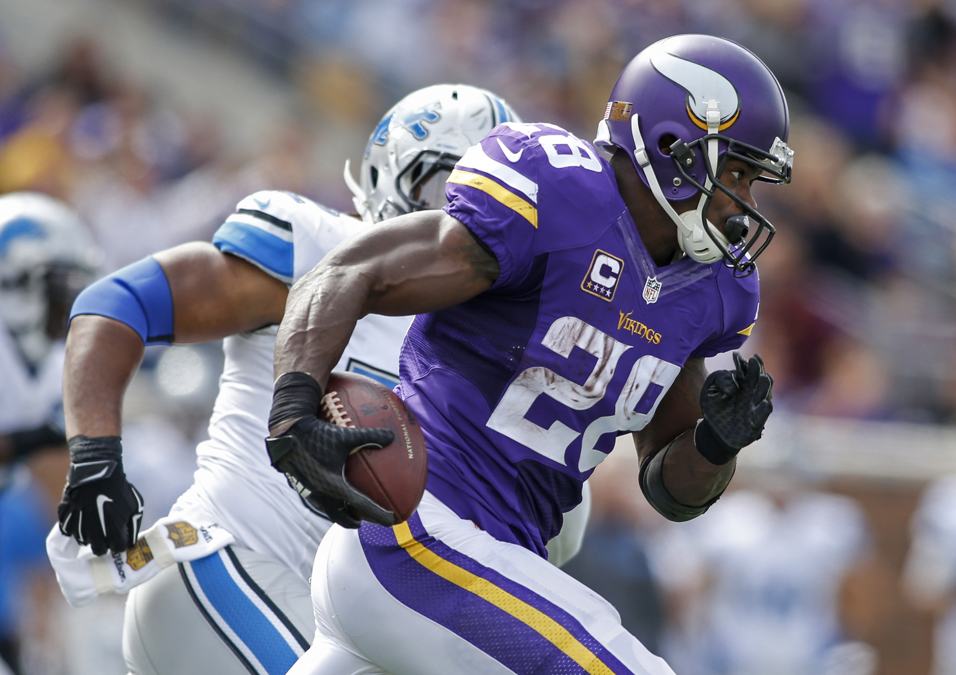 Adrian Peterson of the Minnesota Vikings rushes with the ball against