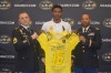 Charles Oliver receives his Army All-American Bowl jersey from Sergeant First Class Steven Haesller (left) and Captain Francis Santana. (Photo: U.S. Army All-American Bowl)