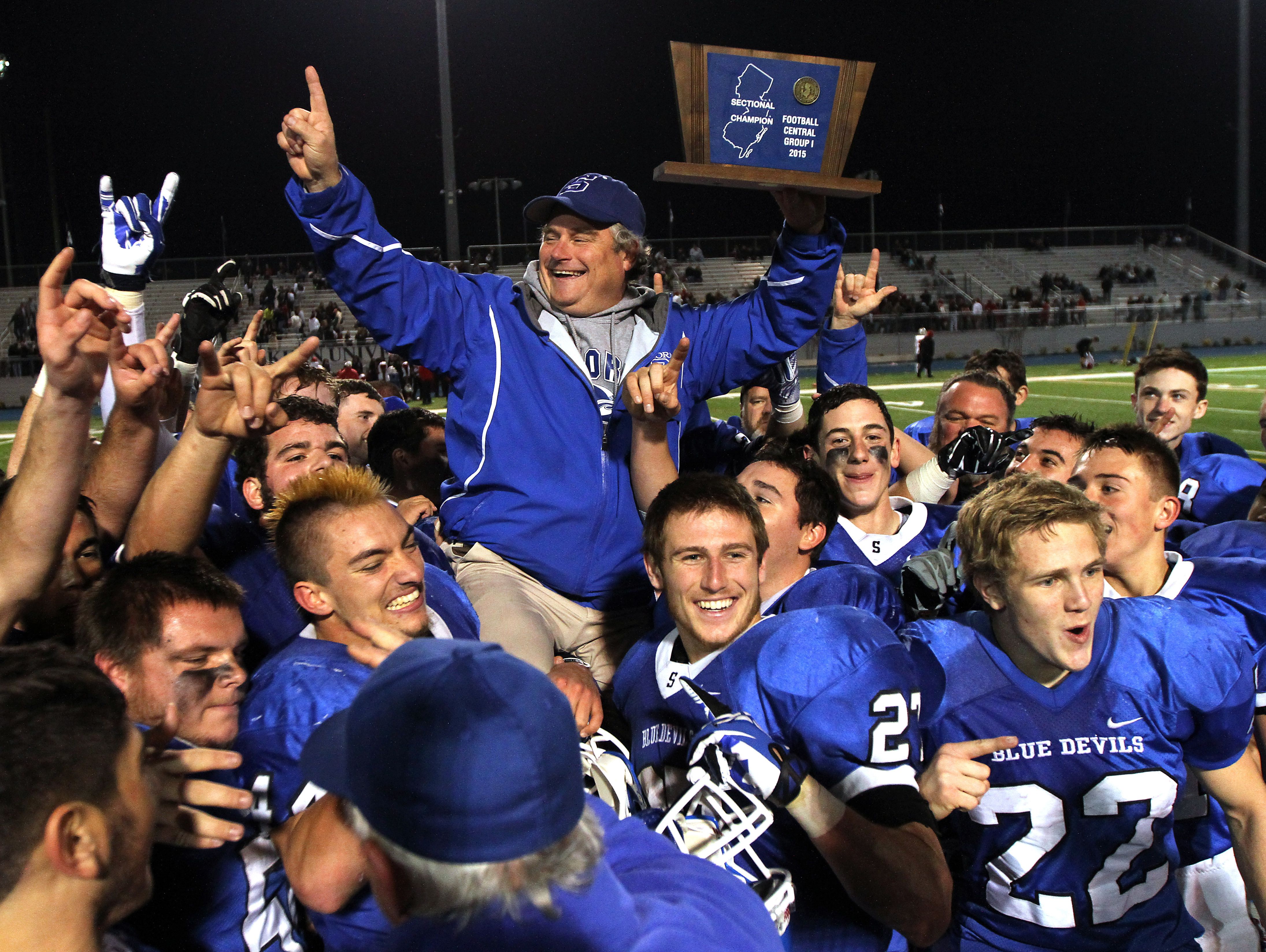 Shore Regional players hoist head coach Mark Costantino after the Blue Devils beat Palmyra in the NJSIAA Central Group I championship game last Saturday.