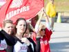 Mother of a player, Tammy Diehl holds high a Riverheads flag as she cheers for the team from the sidelines during the Group 1A football championship in Salem on Saturday, Dec. 12, 2015. Riverheads lost to Galax 7-6.
