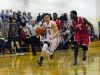 Mooneys' Daniel Everhart drives to the basket around Ecorse senior Antonie Williams Monday, Dec. 28, during the annual Christmas Tournament at Cardinal Mooney.