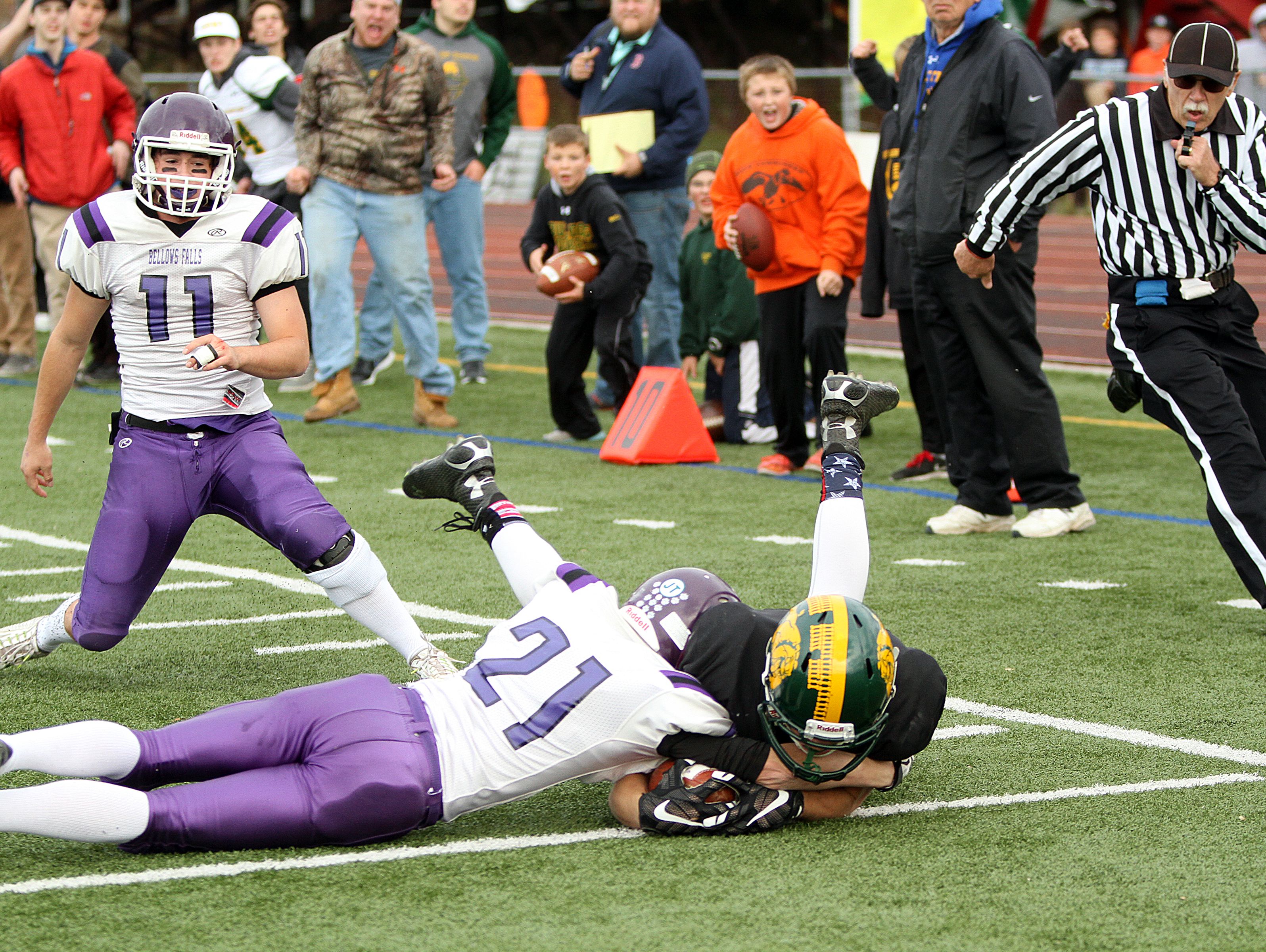 Burr and Burton's Carter Vickers scores a third-quarter touchdown despite the tackle of Bellows Falls' Jacob Streeter the Bulldogs' 28-7 win over Bellows Falls in the Division II state high school football championship game on Saturday, Nov. 7, 2015.