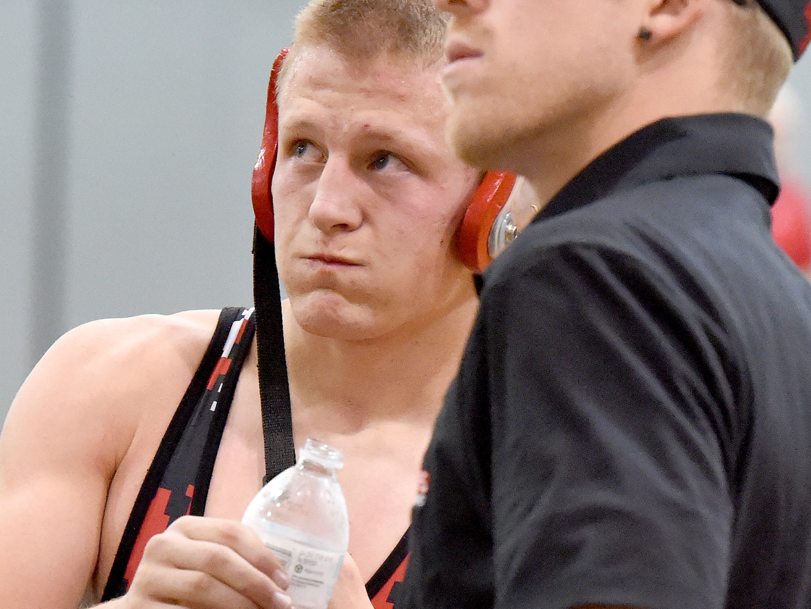 Riverheads' Garret Shultz looks to the scoreboard as he drinks water and talks to one of his coaches during a break in his match against Buffalo Gap's Josh Stagner in a 145-pound weight class during the Bison Wrestling Quad in Swoope on Wednesday, Jan. 6, 2016. Shultz won the match.