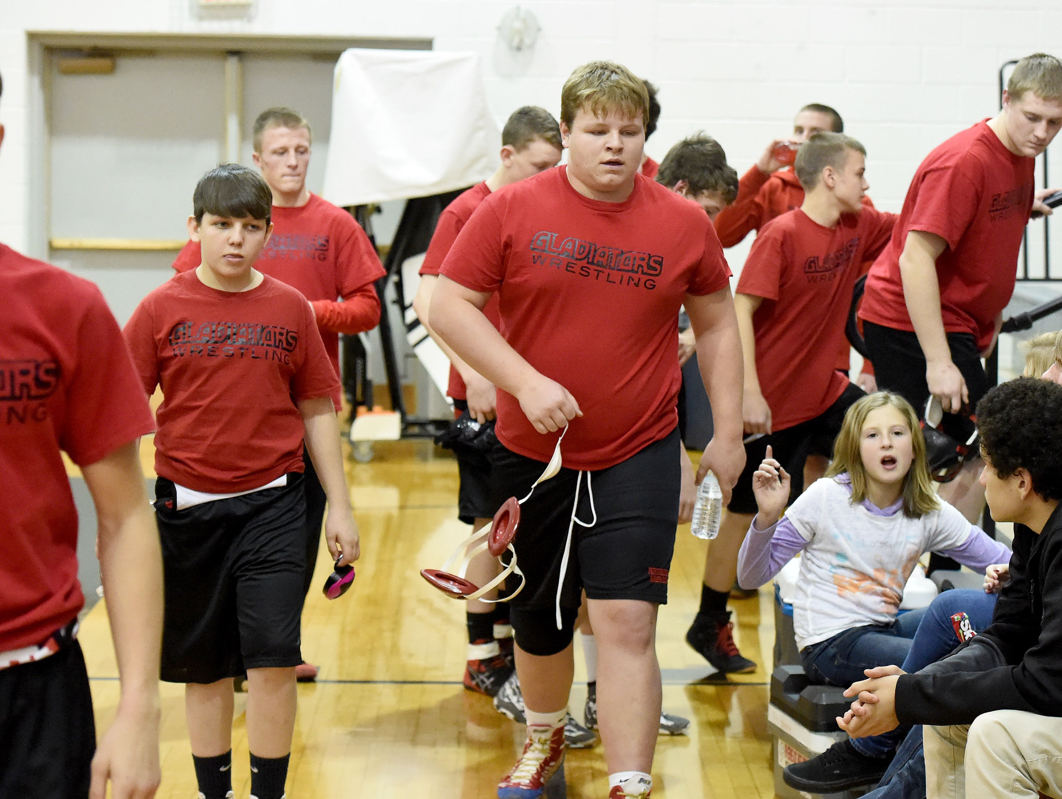 Riverheads' James Rea (center) walks with his team as the move from one mat to the other after wrestling against Buffalo Gap and preparing to take on Stuarts Draft during the Bison Wrestling Quad in Swoope on Wednesday, Jan. 6, 2016. Rea won the match with a pin.