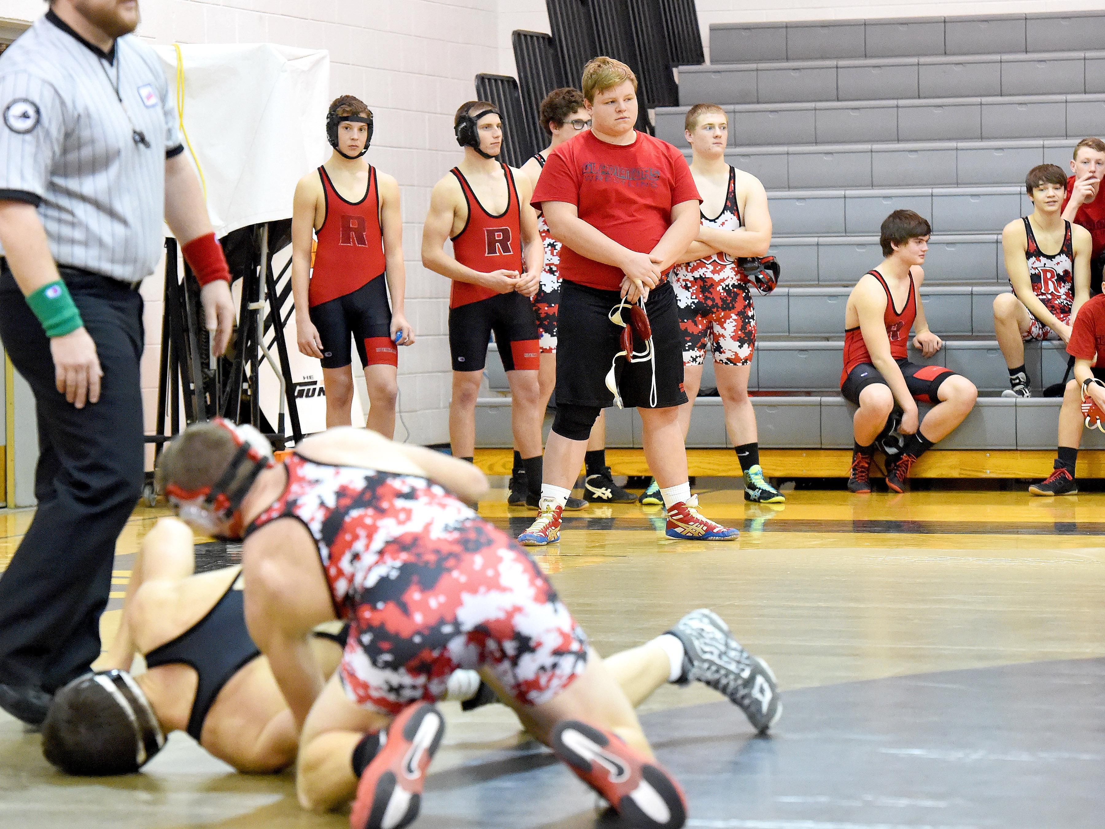 Riverheads' James Rea (center) stands with hands clasped in front of him as he waits his turn to wrestle during the Bison Wrestling Quad in Swoope on Wednesday, Jan. 6, 2016.