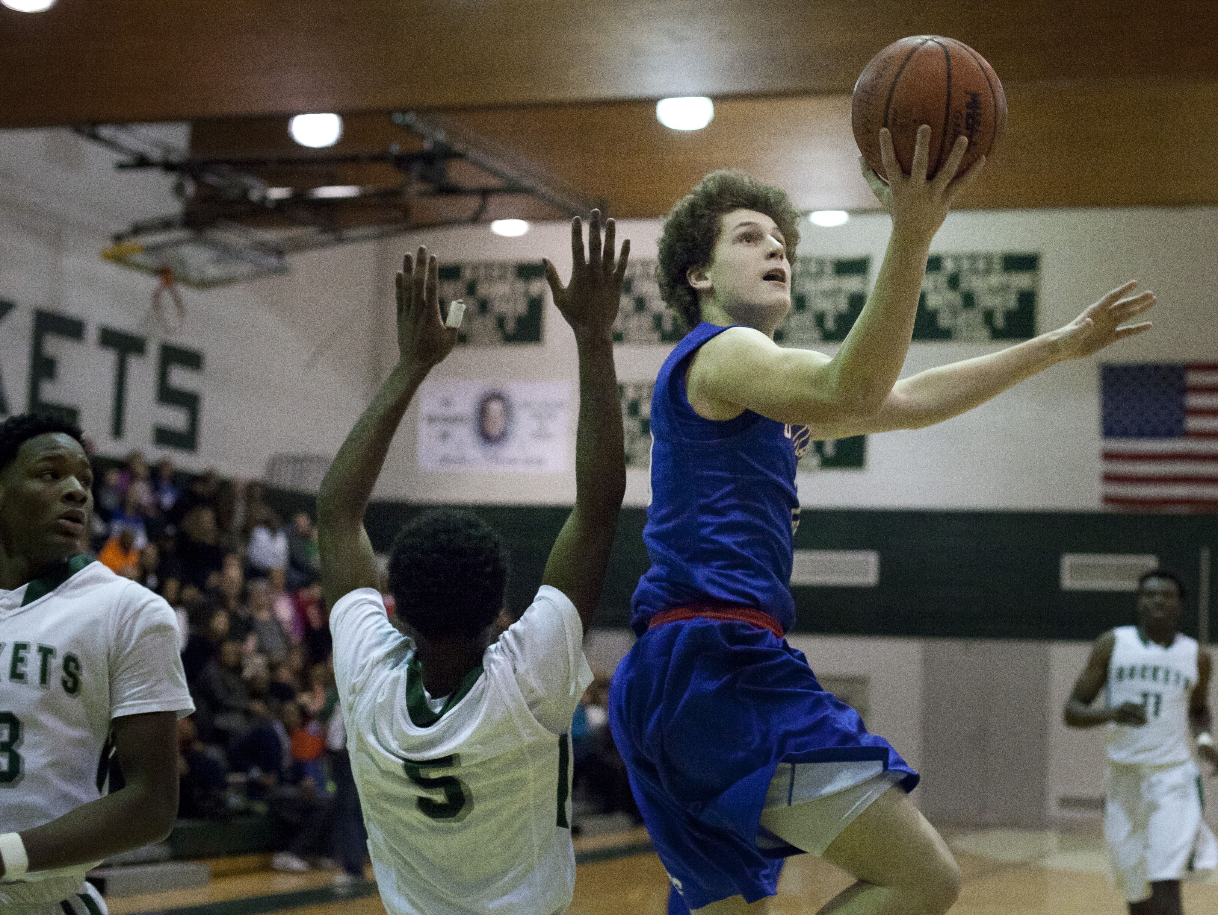 St. Clair sophomore Ben Davidson goes for a shot during a basketball game Tuesday, Jan. 12, 2015 at New Haven High School.