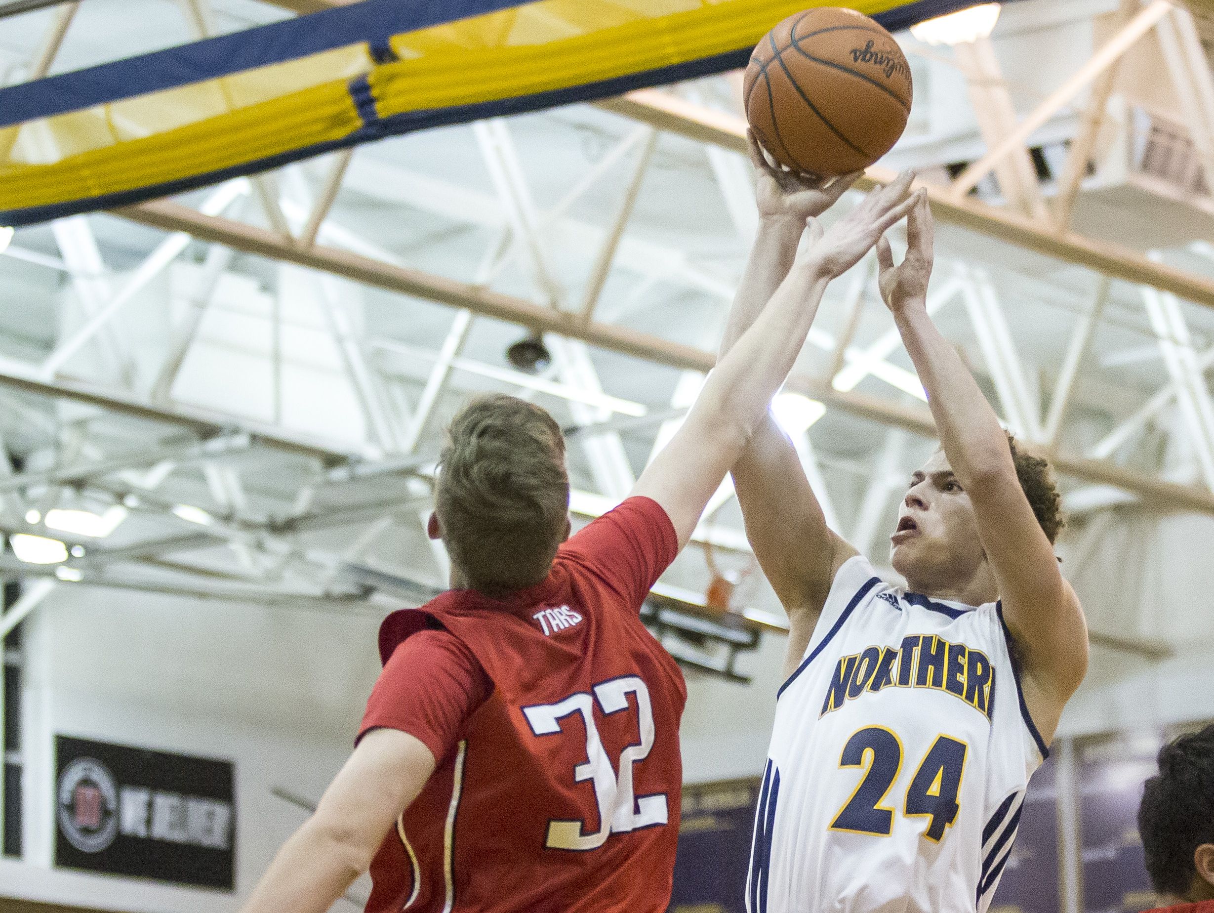 Port Huron Northern senior Geryd Welsh takes a shot in front of Anchor Bay junior Ben Ratkov during a basketball game Thursday, Feb. 11, 2016 at Port Huron Northern High School.