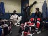 Port Huron goalie Ally Fetterly, left, listens as head coach Ben Poink speaks with players in the locker room during a practice at McMorran Arena in Port Huron.