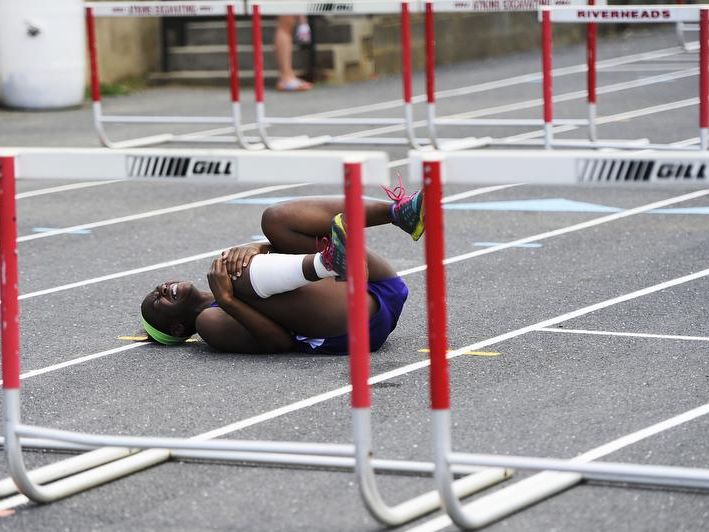 Waynesboro's Jayna Jean-Jules collapses on the track after hurting her leg in the 100-meter hurdles during the Augusta County Invitational Track Meet on Saturday, April 26, 2014, in Greenville.