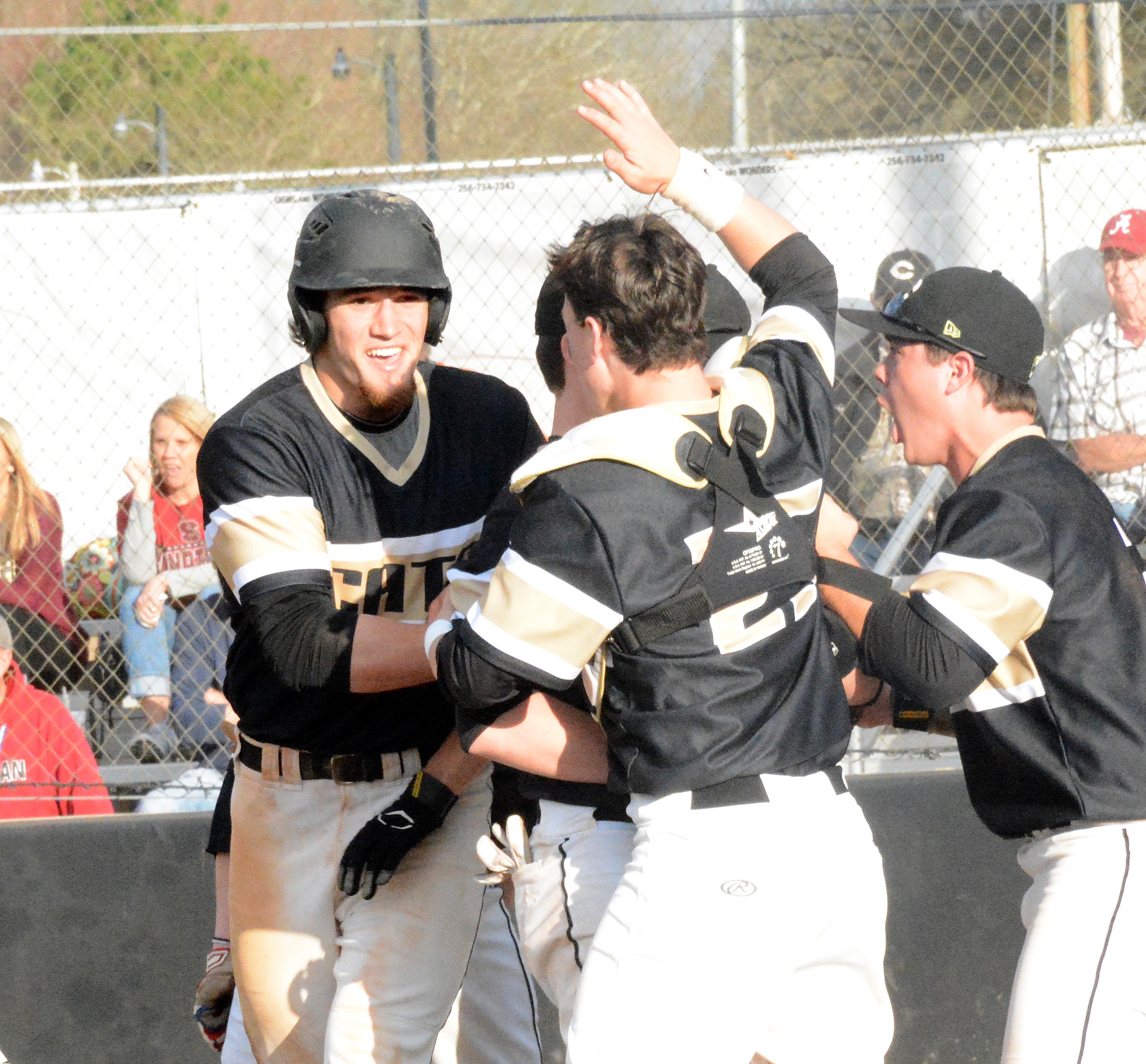 Cullman's Owen Lovell celebrates with teammates after stealing homer with the winning run. (Photo: Rob Ketcham/The Cullman Times).