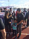Coach Steve Baik and his family look at the American Family Insurance ALL-USA Coach of the Year trophy (Photo: Matt Wade, USA TODAY Sports)