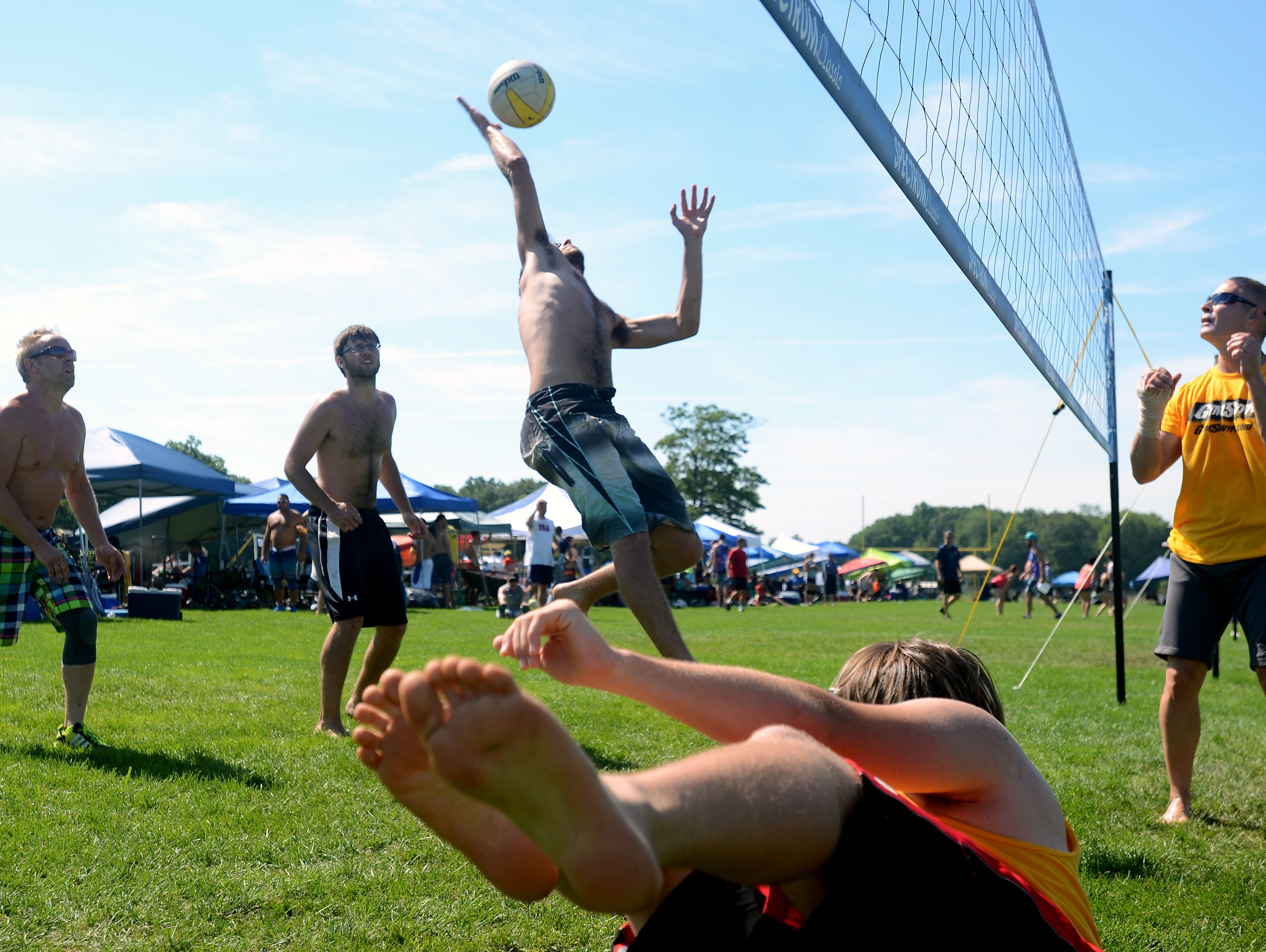Gage Liberati, of Novi, hits a ball back Sunday, July 26, during the annual Volleygrass volleyball tournament at Port Huron Northern.