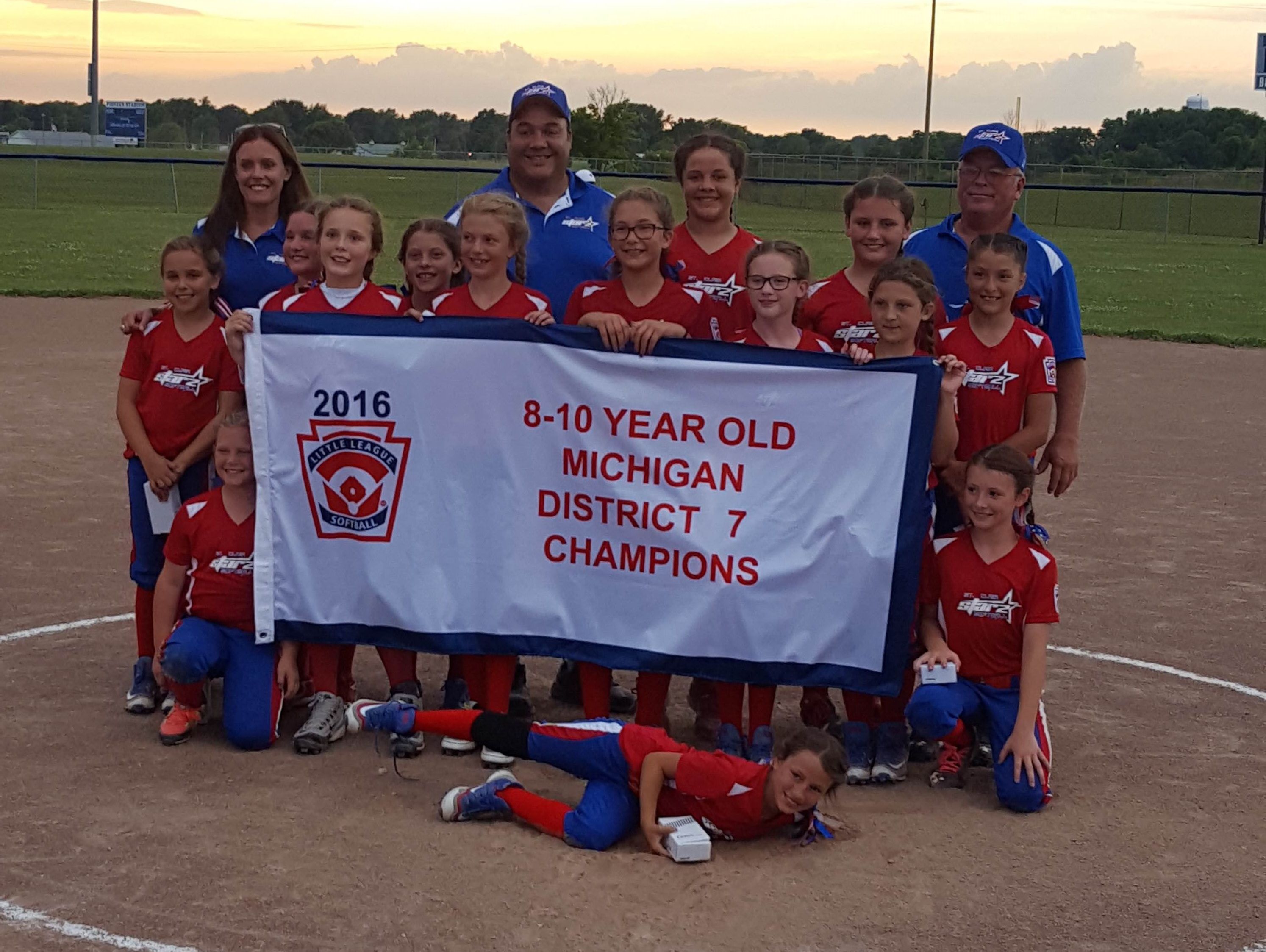 St. Clair 10U softball poses with their district championship banner.