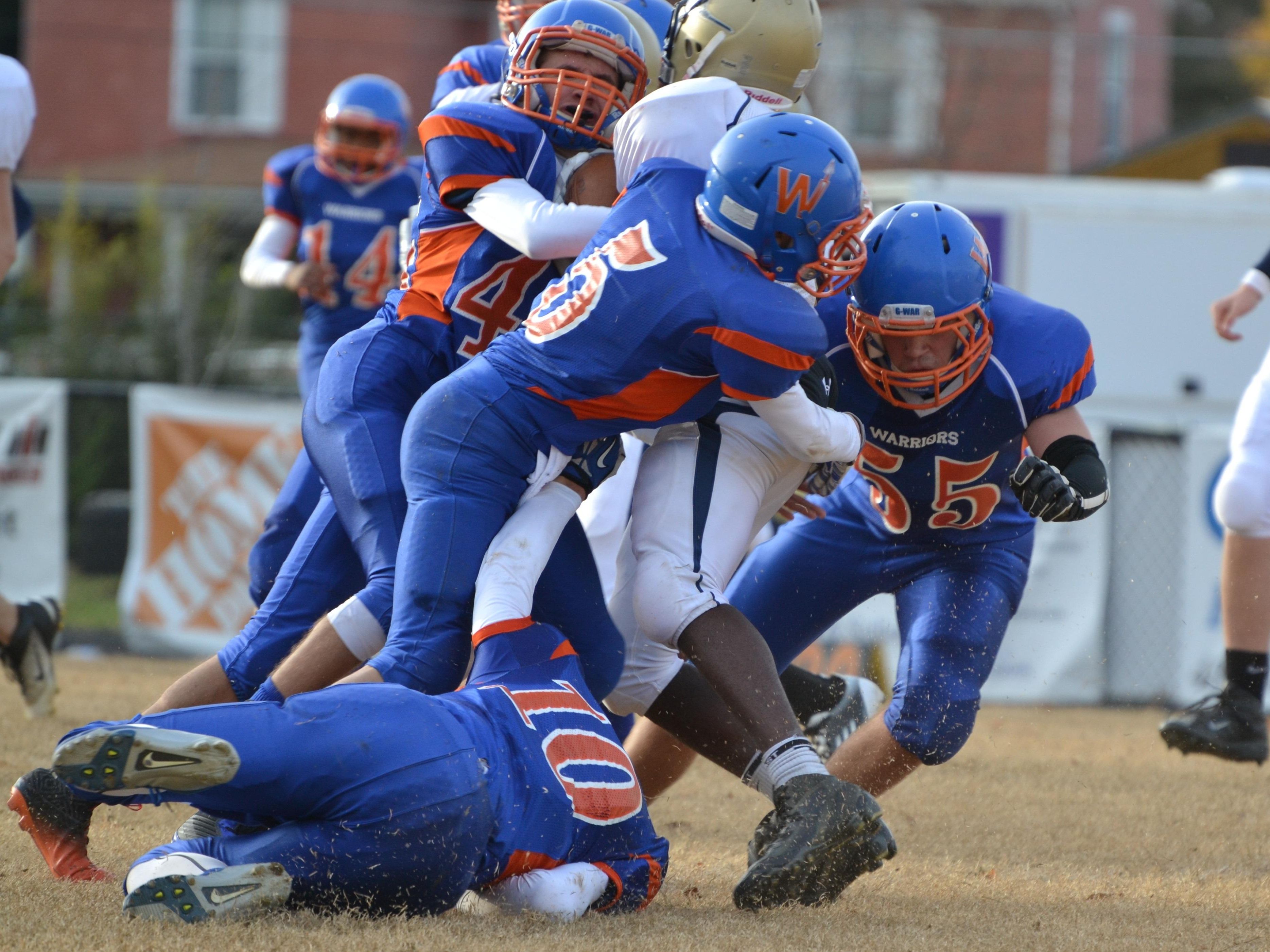 Thomas Musselman, center, Spencer Eckert, right, and Austin Mayo, bottom, wrap up a Victory Christian Academy ball carrier on Saturday during the Warriors final varsity football game of the season. The Warriors won 12-8, finishing out an abbreviated 2-2 campaign, which saw a win against Rappahannock and losses against Massanutten Military Academy and Craig County.