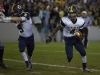 Port Huron Northern sophomore Steve Mason runs the ball as senior Adam Shier clears the way during the Crosstown Showdown Friday, October 23, 2015 at Memorial Stadium in Port Huron.