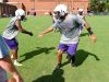 Waynesboro's Jaylen Simmons, right, slaps hands with a teammate in greeting as they take the field during varsity football practice at the school on Friday, Aug. 12, 2016.