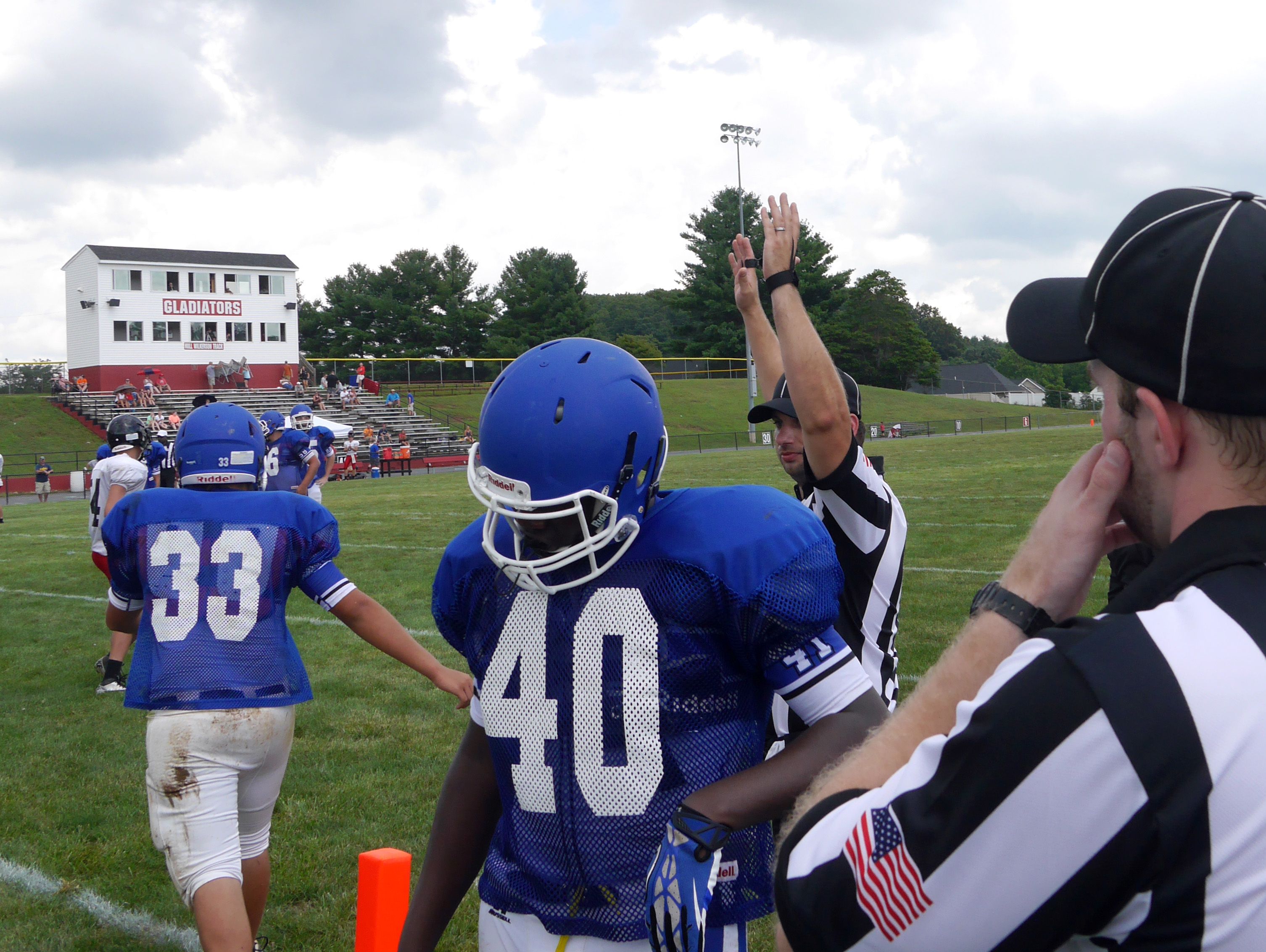 Second-year referee Eric Trynovich of Waynesboro signals a touchdown for James River against Fort Defiance as first-year referee Daniel Roquemore of Staunton watches during the Riverheads High School 2016 football jamboree on Aug. 20, 2016.