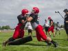 A pair of Big Reds players collide during a tackling drill Friday, Aug 12, during practice at Port Huron High School.