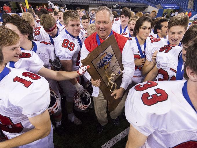 Center Grove coach Eric Moore celebrates with his team after winning the IHSAA Class 6A State Championship game, Nov. 28, 2015, at Lucas Oil Stadium.