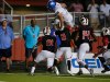 Aug 27, 2016; Cedar Hill, TX, USA; Bishop Gorman Gaels quarterback Tate Martell (18) leaps over Cedar Hill Longhorns cornerback Caleb Lawton (2) in the second quarter at Longhorn Stadium in Cedar Hill. Mandatory Credit: Tim Heitman-USA TODAY Sports ORG XMIT: USATSI-326116 ORIG FILE ID: 20160827_ajw_sh2_347.jpg