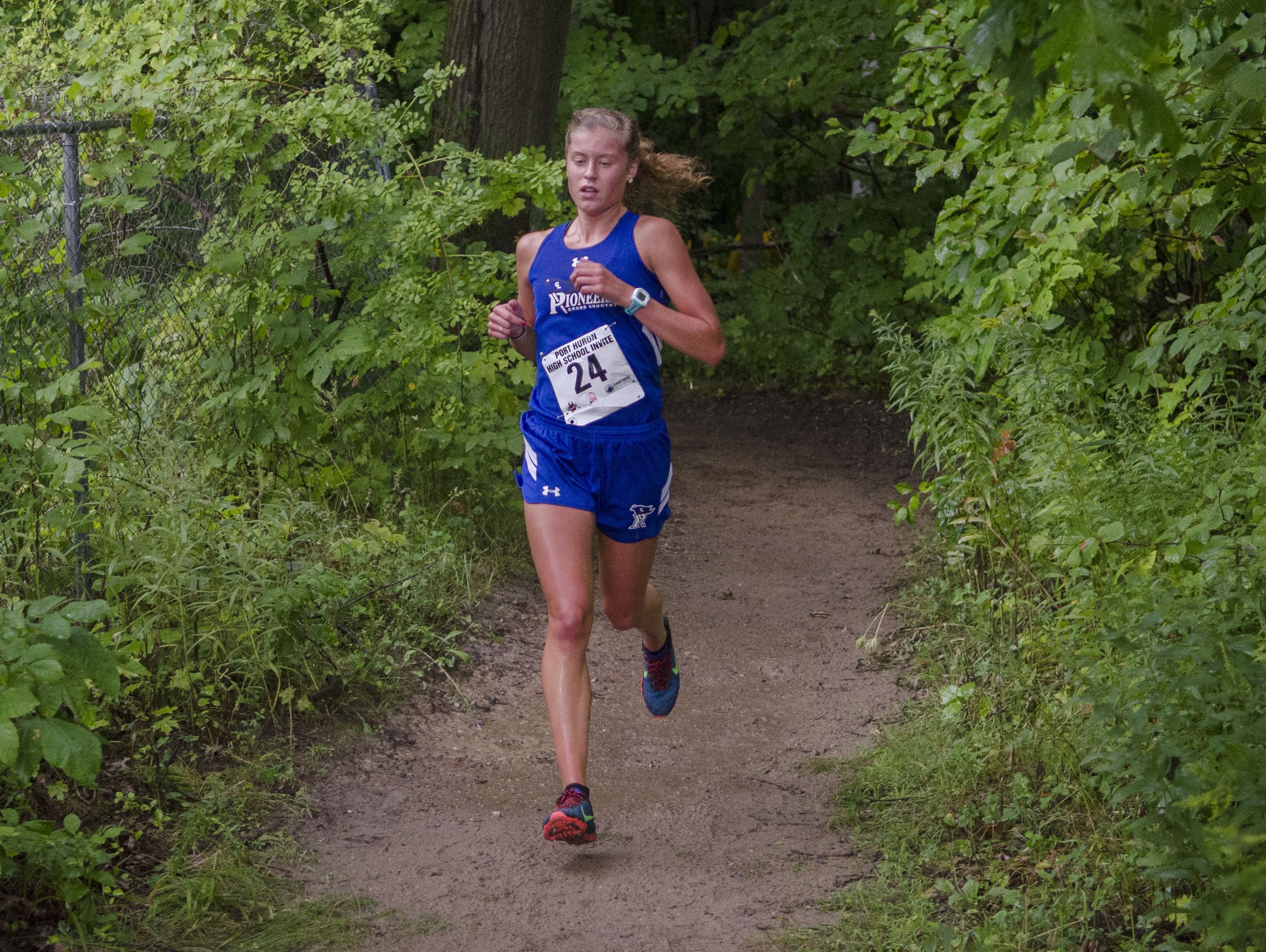 CrosLex's Calli Townsend comes out of the woods at the Port Huron Cross Country Invitational Thursday, Sept. 1, 2016 at Central Middle School. Townsend finished in first place.
