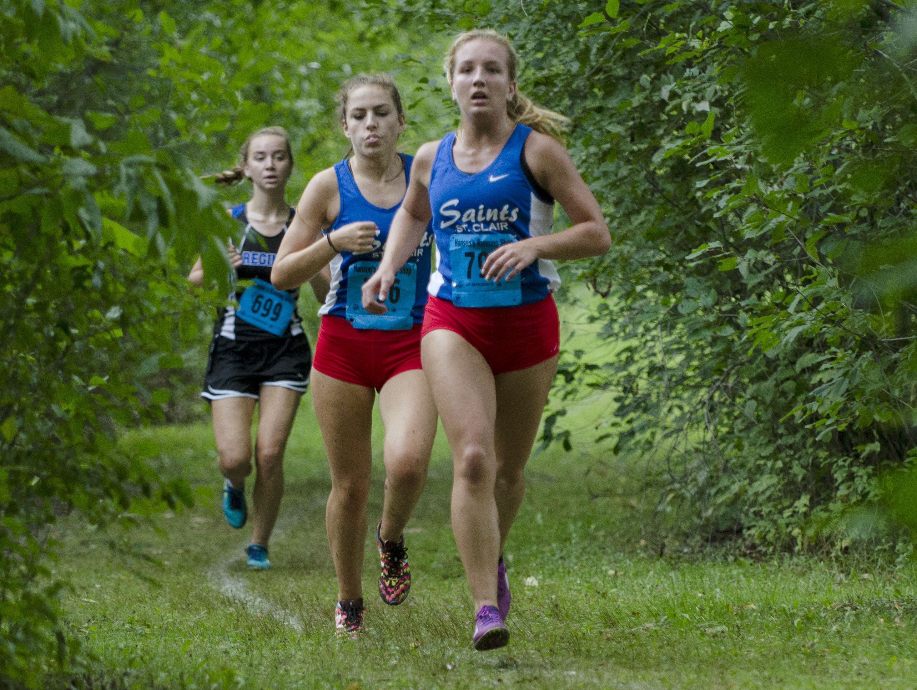 St. Clair's Morgan Markel leads a pack including her teammate Gabrielle Morton, right, Saturday, Sept. 10 at the Algonac Muskrat Cross Country Classic at Algonac High School. Markel finished second with a time of 20:18 and Morton finished first with a time of 20:12