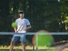 Huskies' John Betrus hits the ball over the net Monday, Sept. 12, during boys tennis action at Sanborn Park tennis courts.