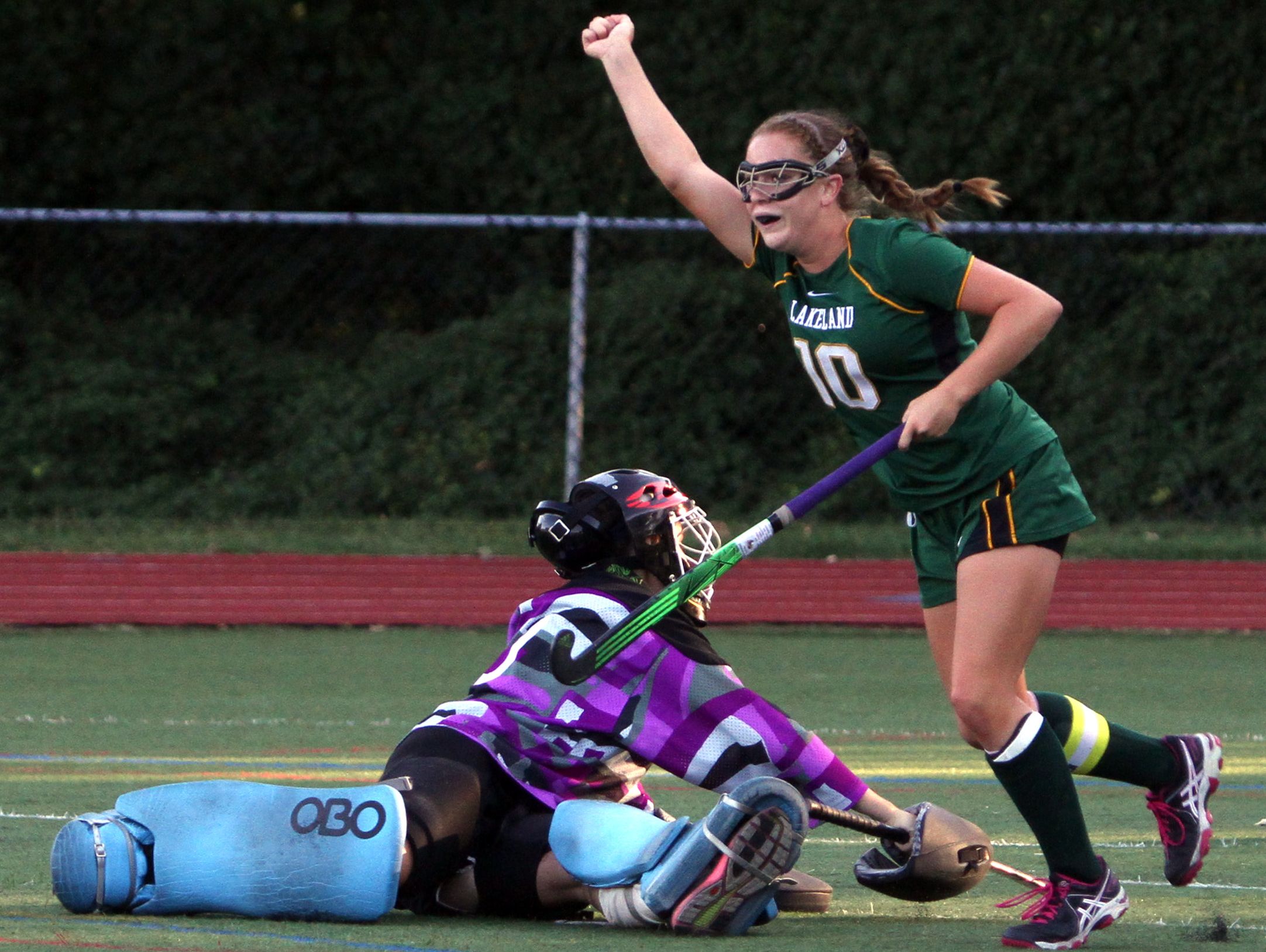 Lakeland's Meghan Fahey celebrates after beating Rye goalie Maggie Devlin for Lakeland's third goal during a game at Rye High School on Sept. 15. The Hornets defeated Rye 3-1.