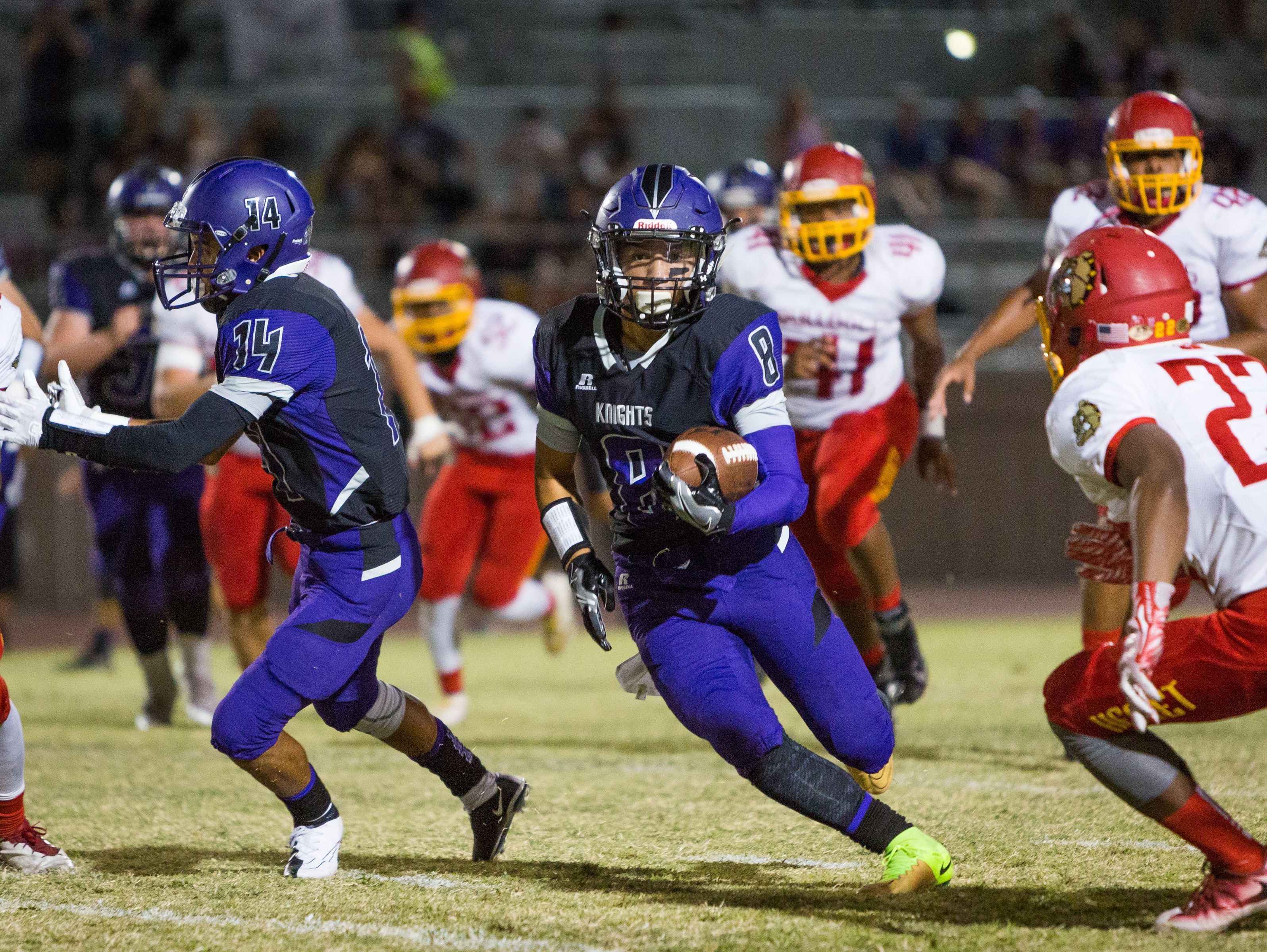 Kaleb Welmas (#8) runs the ball right down the middle for a Shadow Hills first down.