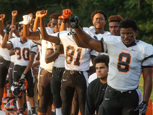 Almost the entire Withrow team raised their fists during national anthem (Photo: Cameron Knight, Cincinnati.com)
