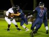 Estero High School's Jonathan Rauss(23) takes down Gulf Coast High School's Demarcus Townsend(1) during a game against Gulf Coast High School in Estero, Fla., on Friday, Sept. 23, 2016.