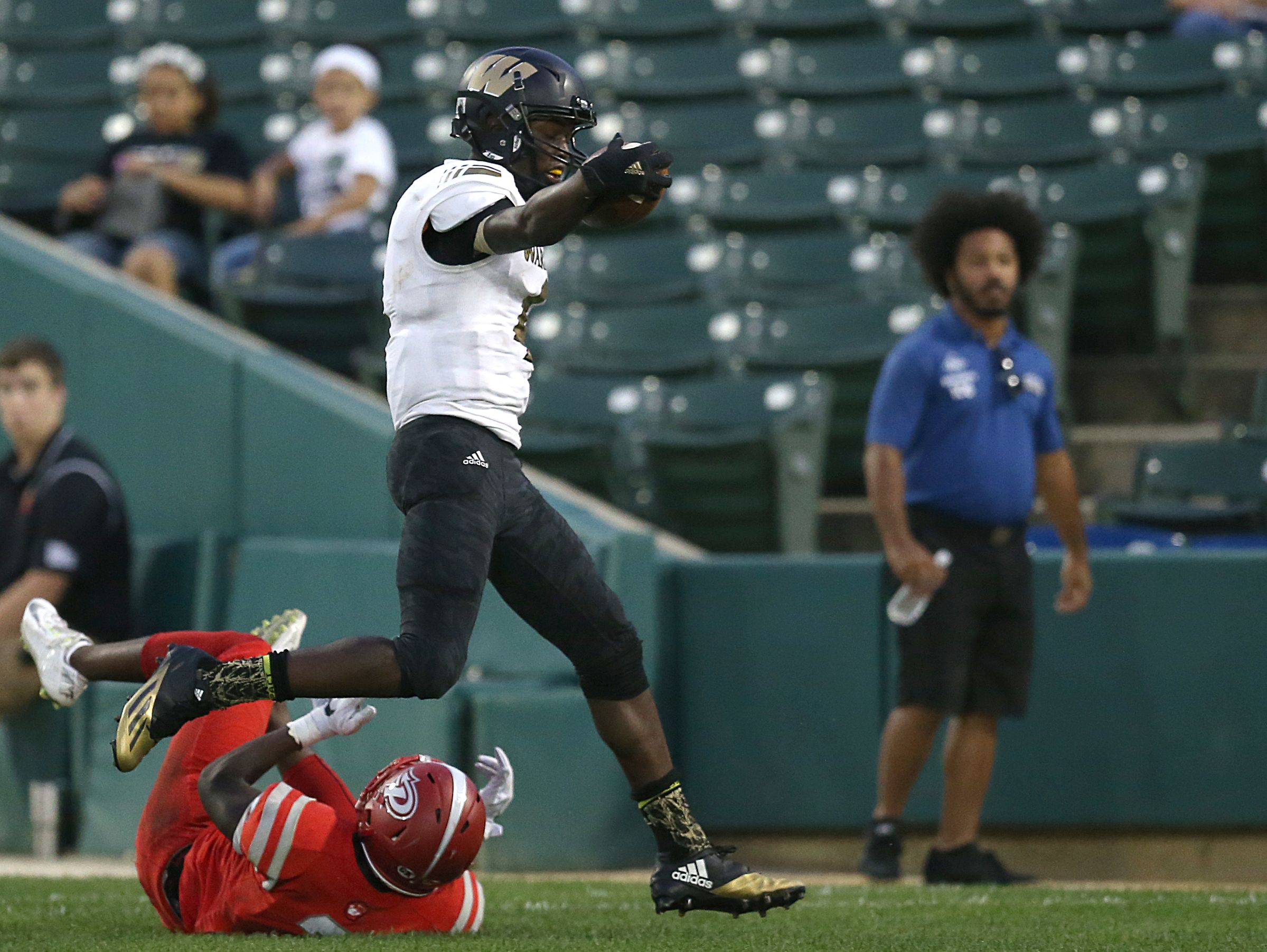 Warren Central Warriors wide receiver David Bell (4) runs in a touch down during first half action of the Gridiron Classic at Victory Field, Indianapolis, Friday, September 23, 2016.