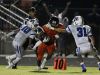 Stratford running back T.J.Carter, center, runs the ball between Marshall County's Tre Crutcher (10) and Donathon Tears (31) after pulling in a pass reception during second half of a high school football game on Friday, Sept. 23, 2016, in Nashville, Tenn. Stratford won 28-21.
