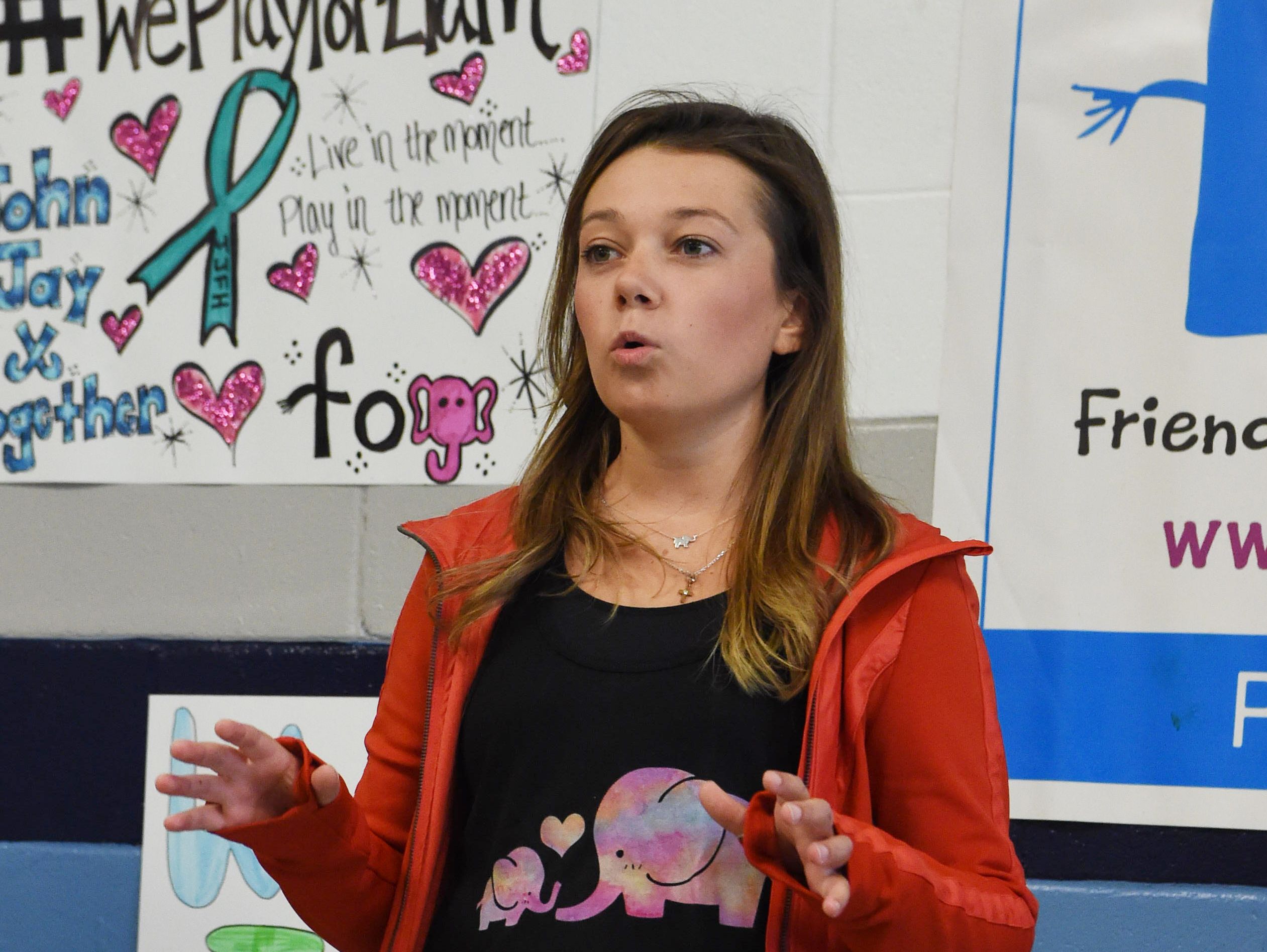 Jaclyn Murphy, 21, the inspiration behind the Friends of Jaclyn Foundation, speaks at John Jay High School before the "adoption" of Liam, 5, by the school's field hockey team.